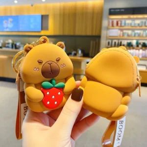 capybara muenzetui als schluesselanhaenger, 3d sculpted design mit rosa backen und roter erdbeere