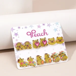 buntes capybara ohrstecker set mit verschiedenen themen wie frucht, dinosaurier und boba tee