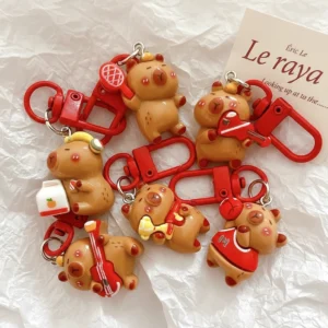 Aufsicht auf 6 verschiedene Capybara Taschenanhänger aus Resin im Sport und Musik Design