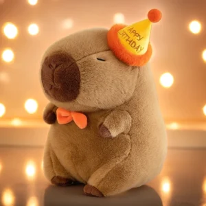 Geburtstags Capybara Kuscheltier mit gelbem Partyhut und orangener Fliege