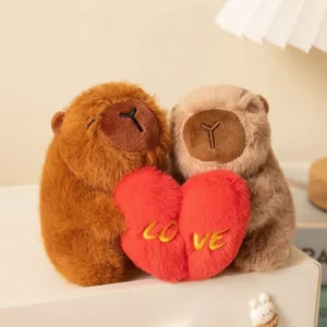 Paar aus braunen und beigen Capybara Plüsch Schlüsselanhänger mit magnetischer Verbindung, die sich umarmen