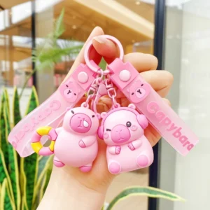 Rosa Capybara Schlüsselanhänger und Taschenanhänger aus PVC, zwei Designs: mit Kopfhörer und mit Schwimmring, mit rosa Bändern und Legierung Verschluss