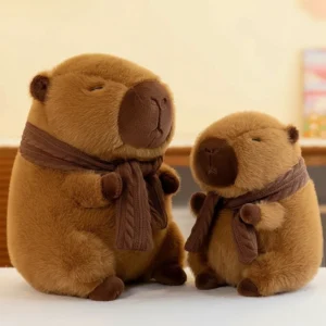 Zwei flauschige braune Capybara Kuscheltiere mit braunen Strickschalen, geschlossenen Augen und ruhigem Ausdruck
